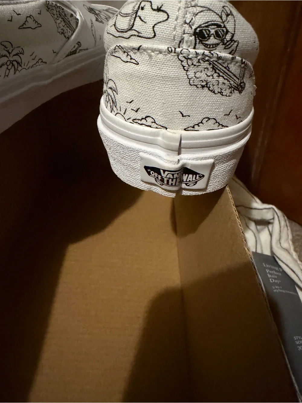 Vans White Slip-On Sneakers with Black skeleton doodles